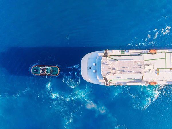 Sleepboot slepen grote containerschip Blue Sea Port. Bovenaanzicht van de luchtfoto — Stockfoto