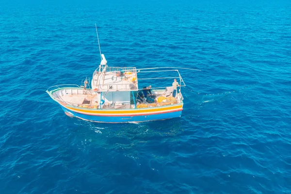 Barco de pesca em água do mar azul, pescadores definir redes para peixes. Vista aérea superior — Fotografia de Stock