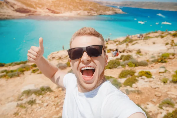 Manliga turist solglasögon tar selfie foto på stranden Blue Lagoon Comino Malta — Stockfoto
