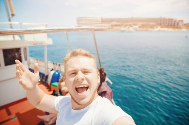 Erkek turist yolcu gemisinde selfie çekiyor, yolcu gemisi Akdeniz 'de seyahat ediyor.