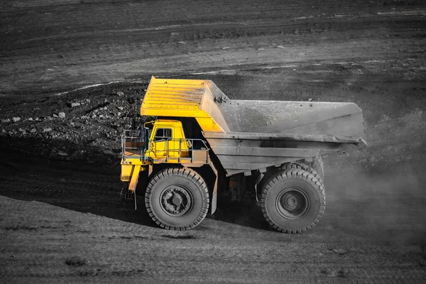 Big yellow mining truck empty body for anthracite. Open pit mine, extractive industry for coal