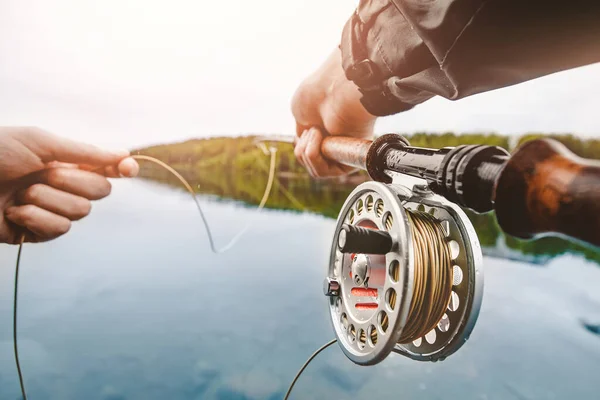 Coil of fly fishing rope, man hands holding rod — Stock Photo, Image