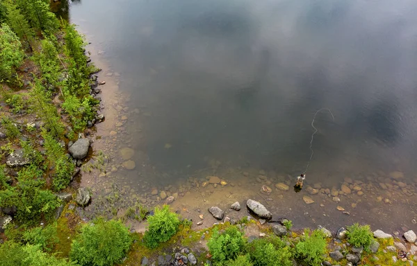 El pescador lanza caña en el río de montaña en botas de pesca con mosca salmón, por la mañana. Vista superior aérea —  Fotos de Stock