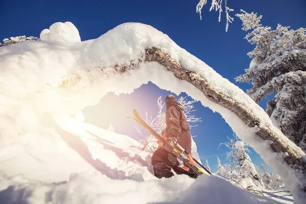 Skier skiing downhill during sunny day in mountains and forest. Extreme winter sports — Stock Photo, Image