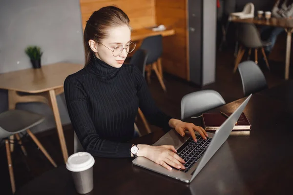 Young female businessman conducts business online computer home with coffee mug, while quarantine from coronavirus in country