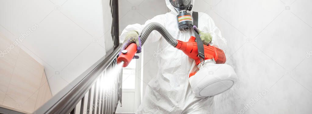 Worker specialist in white hazmat suits cleaning disinfecting cells coronavirus epidemic, clear virus home pandemic