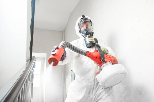 Disinfecting prevent COVID-19, specialist in hazmat suit with disinfect in hotel. Concept coronavirus pandemic clear