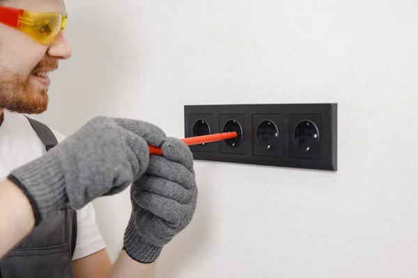 Electrician builder install working switches and sockets black color loft style — Stock Photo, Image