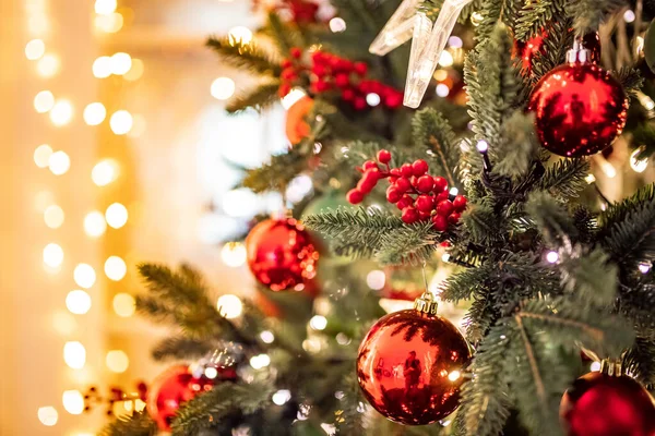 Albero di pino di sfondo di Natale ramo con decorazioni palle rosse regali e stella, con luce bokeh — Foto Stock