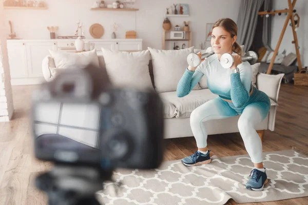 Wpływająca na kondycję kobieta nagrywa wideo trening w domu na kamerze. Pojęcie Styl życia blogger sport i rekreacja — Zdjęcie stockowe