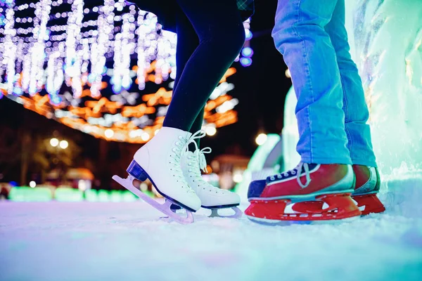 Ice skating lover couple having fun on snow winter holidays night illumination — Stock Photo, Image