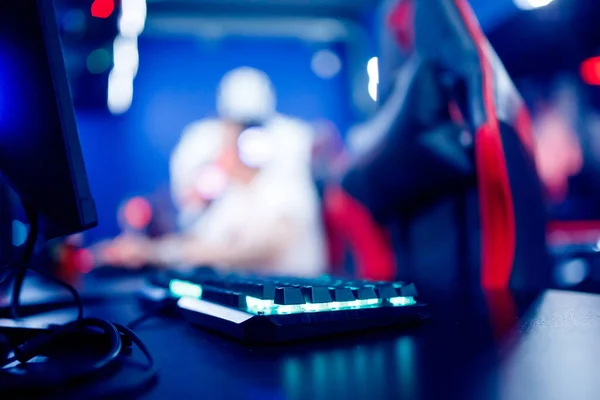 Professional cyber video gamer studio room with personal computer armchair, keyboard for stream in neon color blur background. Soft focus — Stock Photo, Image