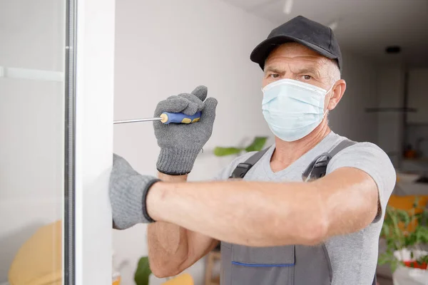 Trabalhador homem instala janelas de plástico e portas com vidro duplo branco — Fotografia de Stock