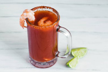 Michelada beer with tomato juice, shrimps, clam and lemon, mexican drink cocktail in mexico clipart