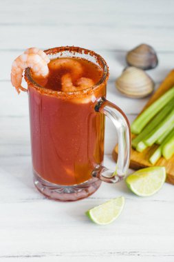 Michelada beer with tomato juice, shrimps, clam and lemon, mexican drink cocktail in mexico clipart