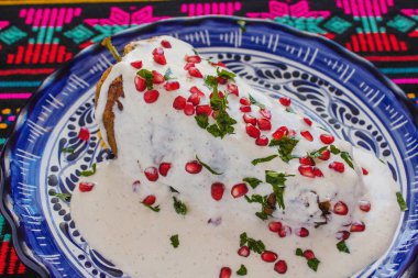 Chiles en Nogada, traditional Mexican cuisine in Puebla Mexico clipart