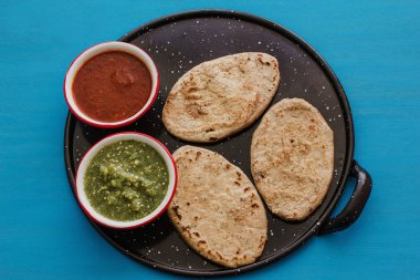 mexican tlacoyos with green and red sauce, Traditional food in Mexico clipart