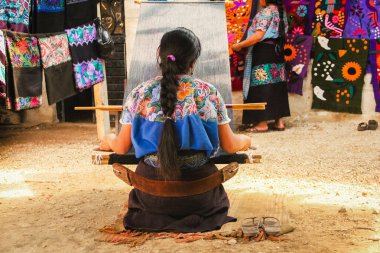 Mexican woman working loom in Chiapas Mexico clipart