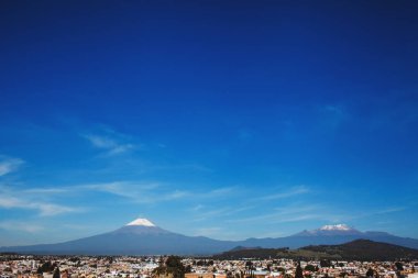 Popocatepetl Volcano and view of Cholula town in Puebla Mexico clipart