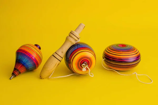 Mexican toys from Wooden, balero, yoyo and trompo in Mexico on a yellow background — Stock Photo, Image