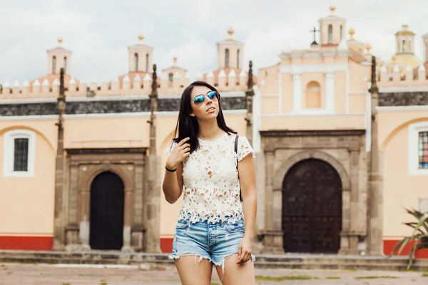 Portrait of a Hispanic women posing along Colonial City in Latin America, mexican girl in Mexico