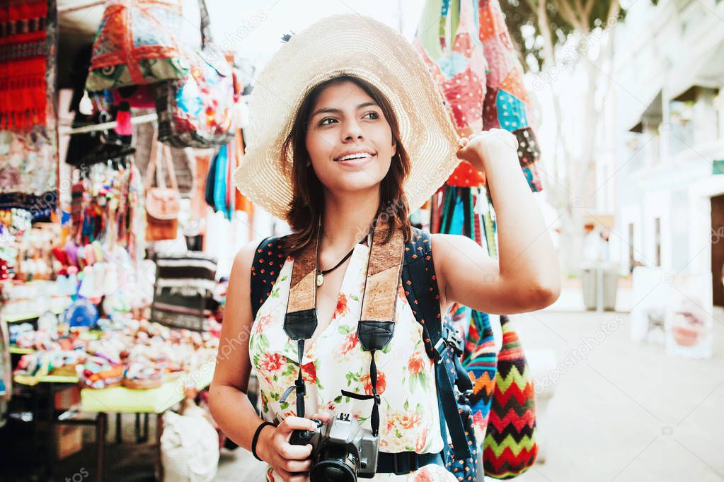 Latin woman backpacker shopping in a Tourist Market in Mexico City, Mexican Traveler in America
