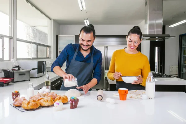 Mexican man baking bread called pan de muerto traditional from Mexico in Halloween