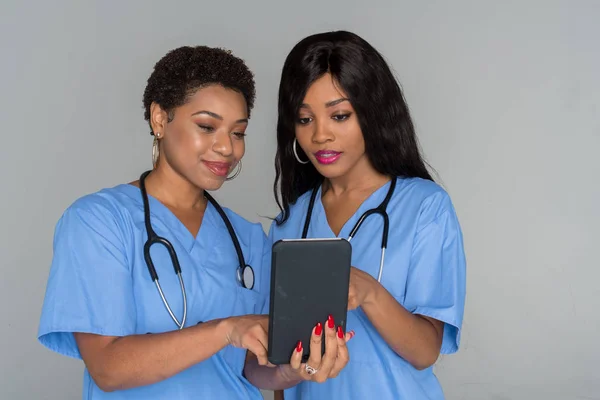 Two African American nurses working their shift in the hospital