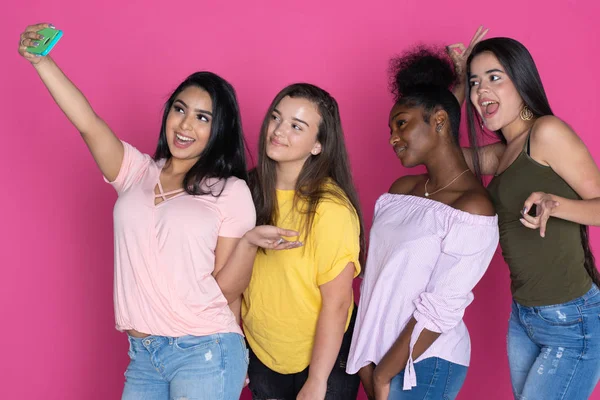 Group of diverse teen together on a pink background