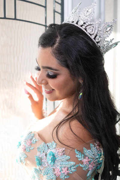 Young teen hispanic girl wearing a quinceanera dress