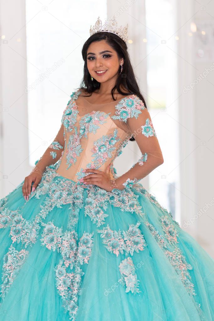 Young teen hispanic girl wearing a quinceanera dress