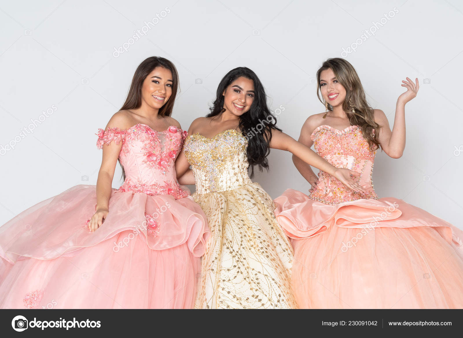 Group Three Teenage Hispanic Girls Wearing Quinceanera Dresses Stock