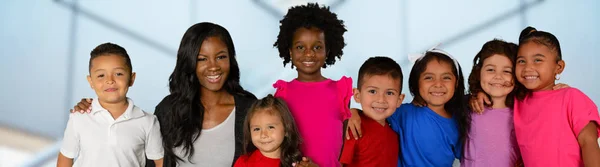 African American teacher and a group of students at school