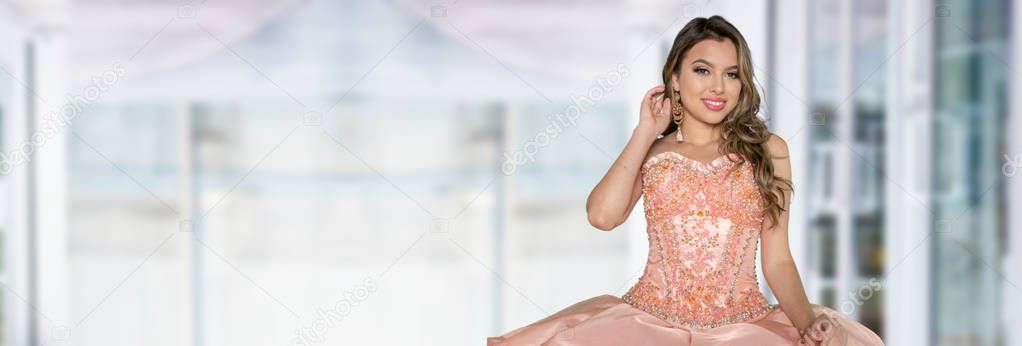 Hispanic teen girl wearing a quinceanera dress for her party