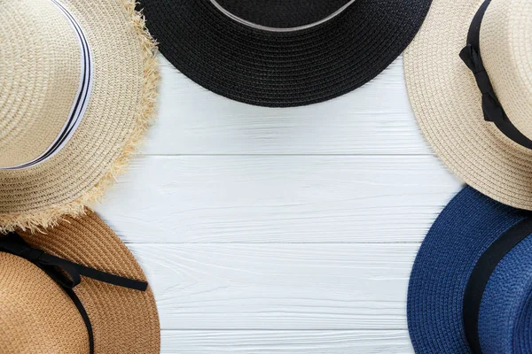 Straw hats with ribbon and bow on white background. Set of beach hats, summer accessory, close up, top view, copy space. Travel, sale concept