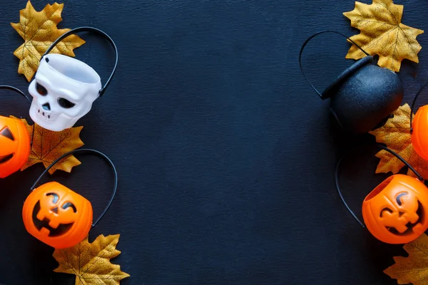 Halloween background with pattern of jack lanterns, cauldrons, skulls on dark blue background. creative decoration, celebration, autumn concept