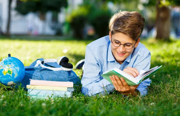 Molto Carino Ragazzo Occhiali Rotondi Camicia Blu Legge Libro Sdraiato — Foto Stock