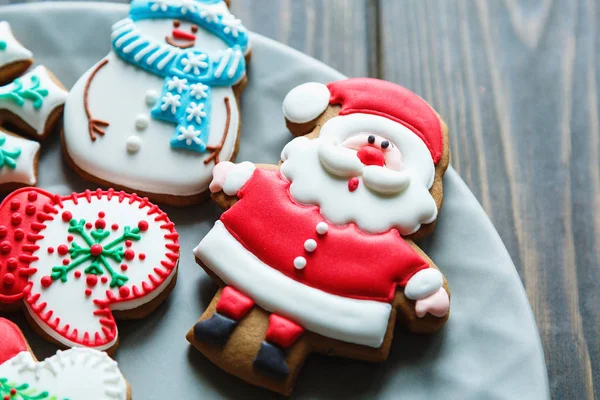 Gingerbread cookies for christmas, new year  on the big plate on  wooden table. Festive, sweet pastry, delicious biscuits. Home celebration, decoration concept