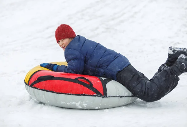 Niño Chaqueta Azul Sombrero Rojo Divirtiéndose Tubo Nieve Chico Está — Foto de Stock