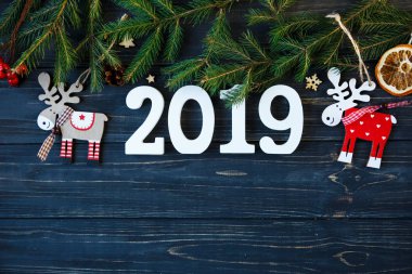 Beyaz ahşap sayılarla 2019 dekor, Ladin ağacı dalları gri ahşap masa üzerinde. Yeni yıl ve Noel dekorasyon konsepti