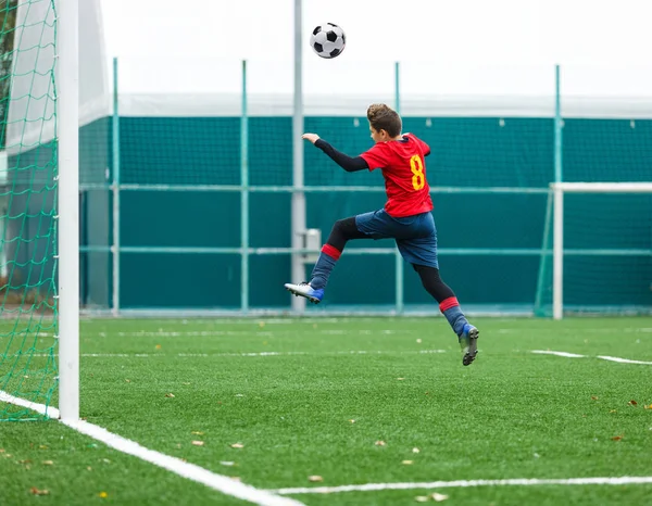 Cute Young Boy Blue Red Uniform Jumps High Ball Football — Stock Photo, Image