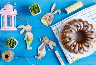  Mutlu Paskalyalar! Havlu, yumurta, ahşap tavşan rabit mavi ahşap arka plan olarak el yapımı kek. Paskalya tatili için dekorasyon