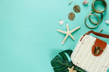 Tropic düz hasır şapka, çanta, deniz yıldızı, kabukları, tekne, küpe yeşil zemin üzerinde yatıyordu. Yaz moda trendy düz yatıyordu, tatil, seyahat kavramı. Kopya alanı ile üstten görünüm. 