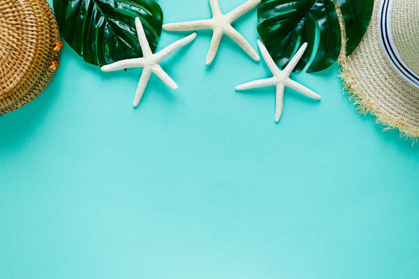 Tropic flat lay with starfish, shells, boat, on green background. Summer fashion flat lay, vacation, travel concept. Top view with copy space. 