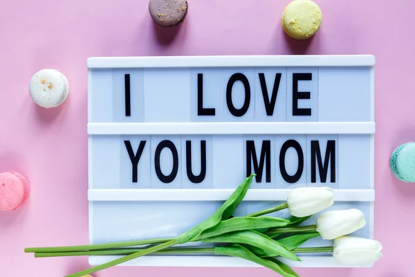 Lightbox with title I love you mom on white wooden table. Mothers day background