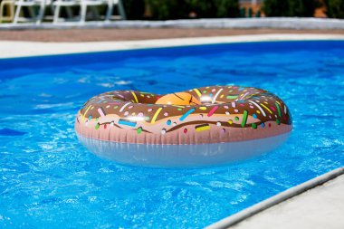 inflatable circle in the pool with blue water on sunny day