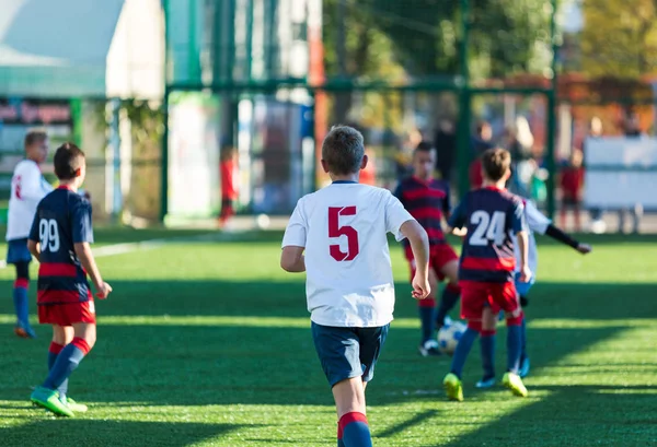 Football training soccer for kids. Boy runs kicks dribbles soccer balls. Young footballers dribble and kick football ball in game. Training, active lifestyle, sport, children activity concept