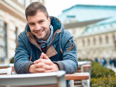 Yakışıklı adam kameraya gülümse, açık, dışarıda bakarak