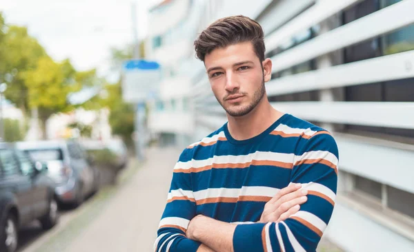 Half length portrait of a beautiful young man in the city. outdoor - outside