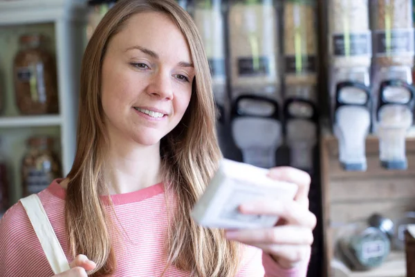 Žena Shopper při pohledu na produkty v udržitelném plastu zdarma G — Stock fotografie